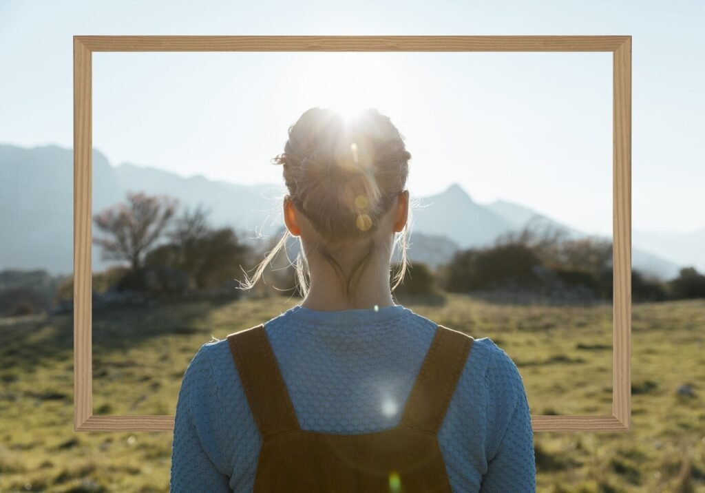 person-holding-frame-with-open-nature-landscape-concept_23-2150063225